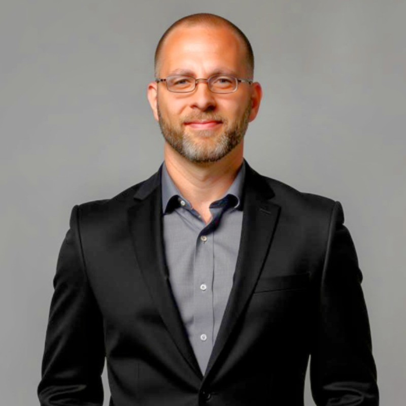 Jonathan Westover, founder and CEO of Human Capital Innovations seen posing for a photo in a black color suit with a grey color shirt